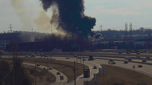Image: Thick smoke rises from metal factory explosion site.